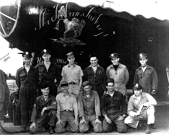 Six men standing and five men kneeling in front of the Clobbered Turkey.